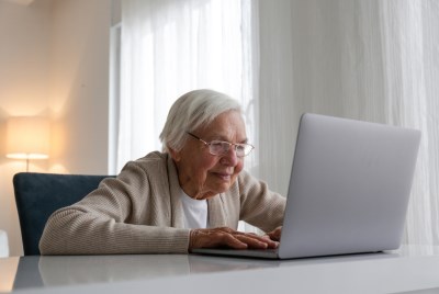 Older woman typing on computer